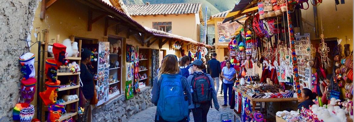 Students browsing a market in Peru